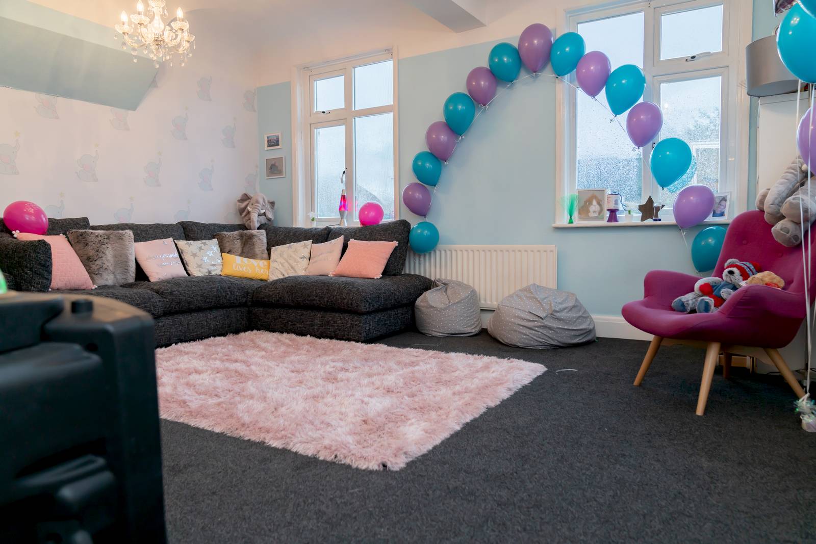 Sofa seating and a balloon arch in the Family Hub