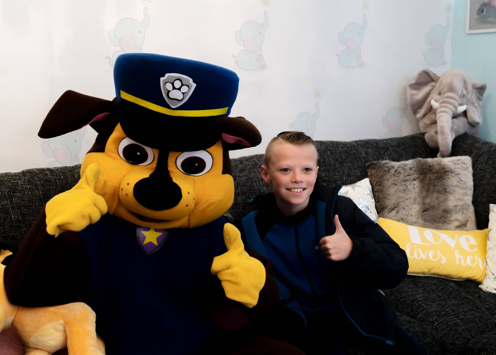 A child sitting on a sofa next to a Paw Patrol character in the Family Hub