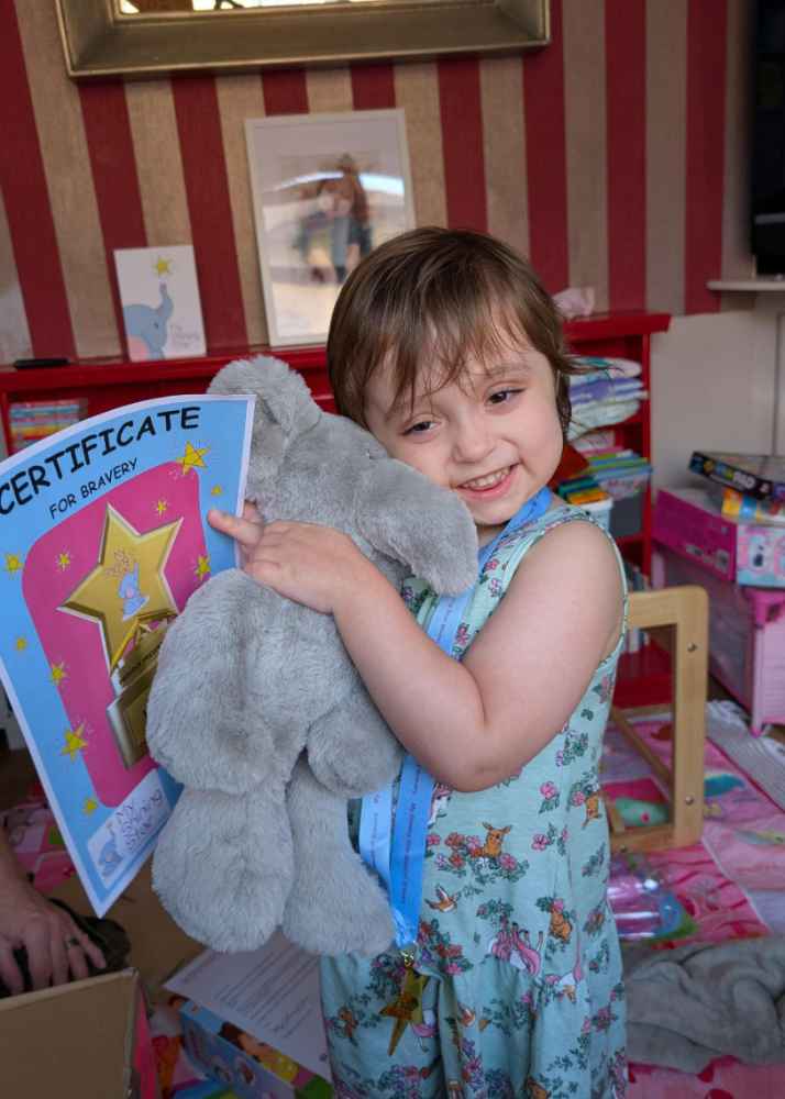 Harriett and Ellie Elephant receiving her certificate for bravery