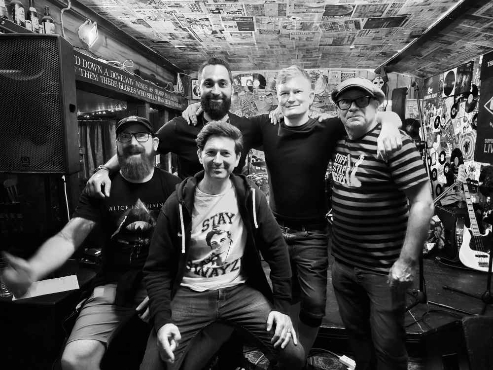 Band posing in black and white