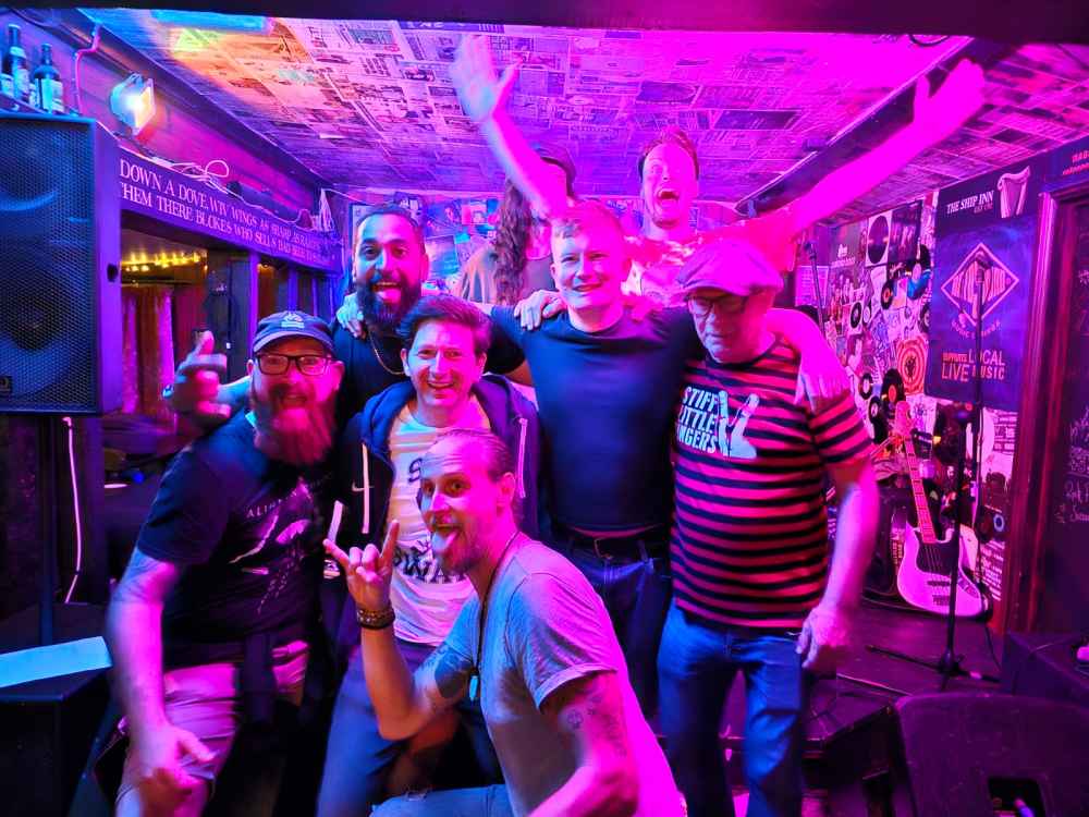 Band posing with fans